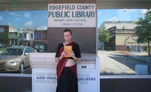 Jillian Hoy, who also claims to be a disciple of the mainstream Hare Krishna Hindu sect, holds up Hare Krishna literature at a rural South Carolina library in 2009